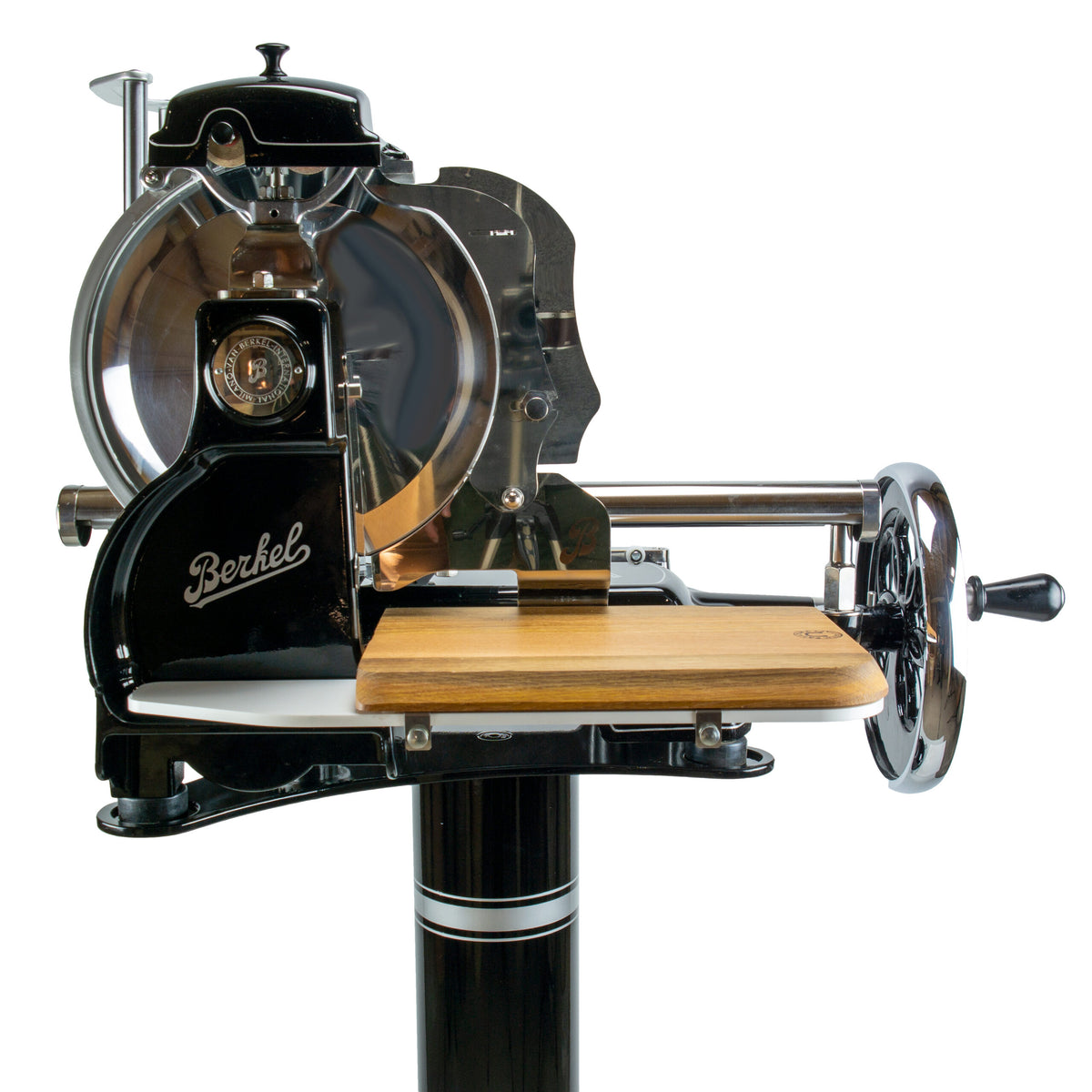 Die Berkel Volano B3 Schwarz Schwungrad-Aufschnittmaschine mit Ständer und Fassholz-Schneidebrett ist eine Fleischschneidemaschine im Vintage-Stil mit schwarzem und silbernem Finish. Sie verfügt über ein Handkurbelrad, eine hölzerne Schneidefläche und ein großes rundes Messer, auf dessen Seite der Herstellername „Berkel“ deutlich zu sehen ist.