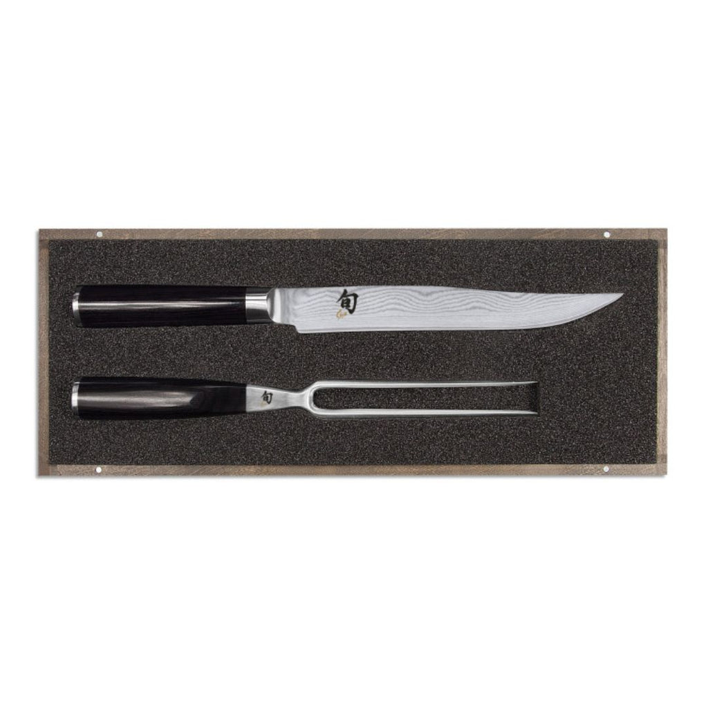 Das KAI Shun Tranchier-Set DMS-200 "THE MAGIC KAI WISHLIST 2025" besteht aus einem Tranchiermesser und einer Tranchiergabel mit dunklen Griffen, elegant verpackt mit einer Schaumstoffeinlage zur stilvollen Präsentation oder Aufbewahrung.