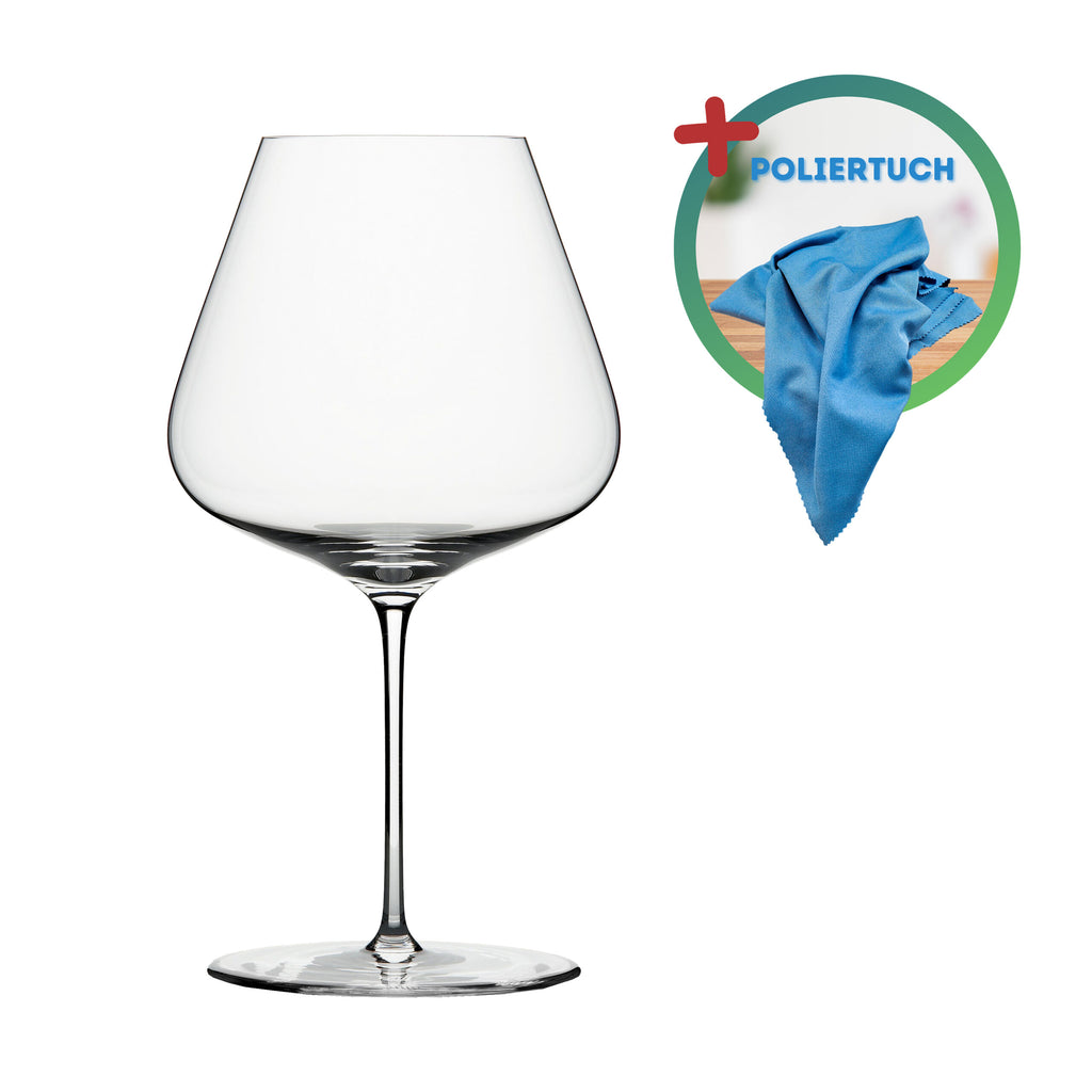 Dargestellt ist ein klares, leeres Weinglas mit breiter Schale und langem Stiel. Rechts oben im Glas ist ein blaues Tuch abgebildet, auf dem in blauer Schrift das Wort „POLIERTUCH“ auf grünem Kreishintergrund und einem roten Pluszeichen steht.