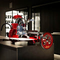 Eine glänzende rot-silberne Vintage-Fleischschneidemaschine von Berkel steht auf einer dunklen Arbeitsplatte in einer modernen Wohnküche. Die Maschine verfügt über komplizierte mechanische Teile und ein handgekurbeltes Rad, das einen Kontrast zum glatten, modernen Hintergrund bildet.